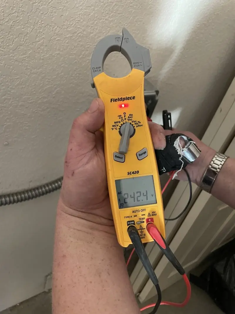 Voltage testing with clamp meter during Electrical Installation Services in Masonville
